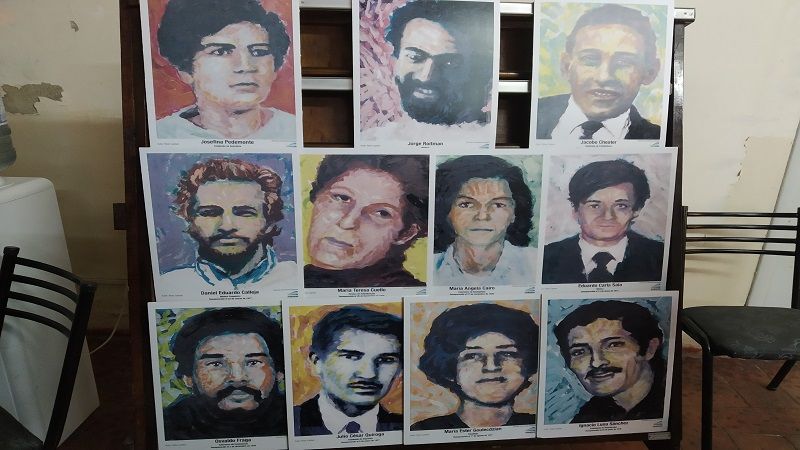 Pinturas de los rostros de les 12 desaparecides durante el Terrorismo de Estado.